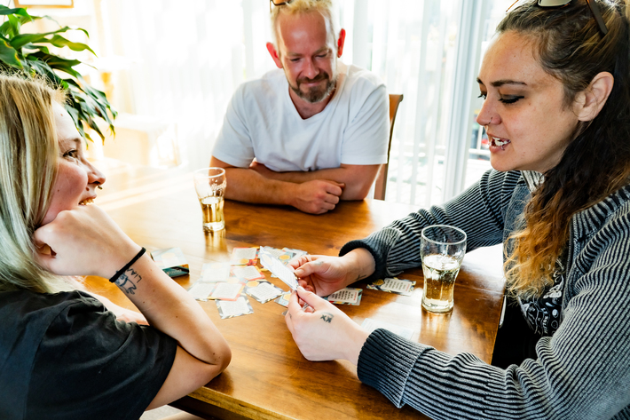 3 people at a table working with the upstander cards